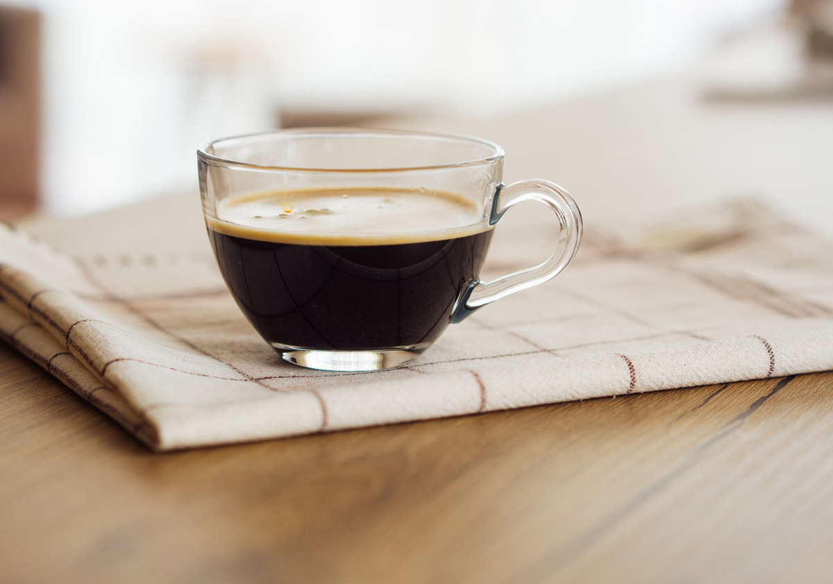 Glass cup of decaf coffee on the table